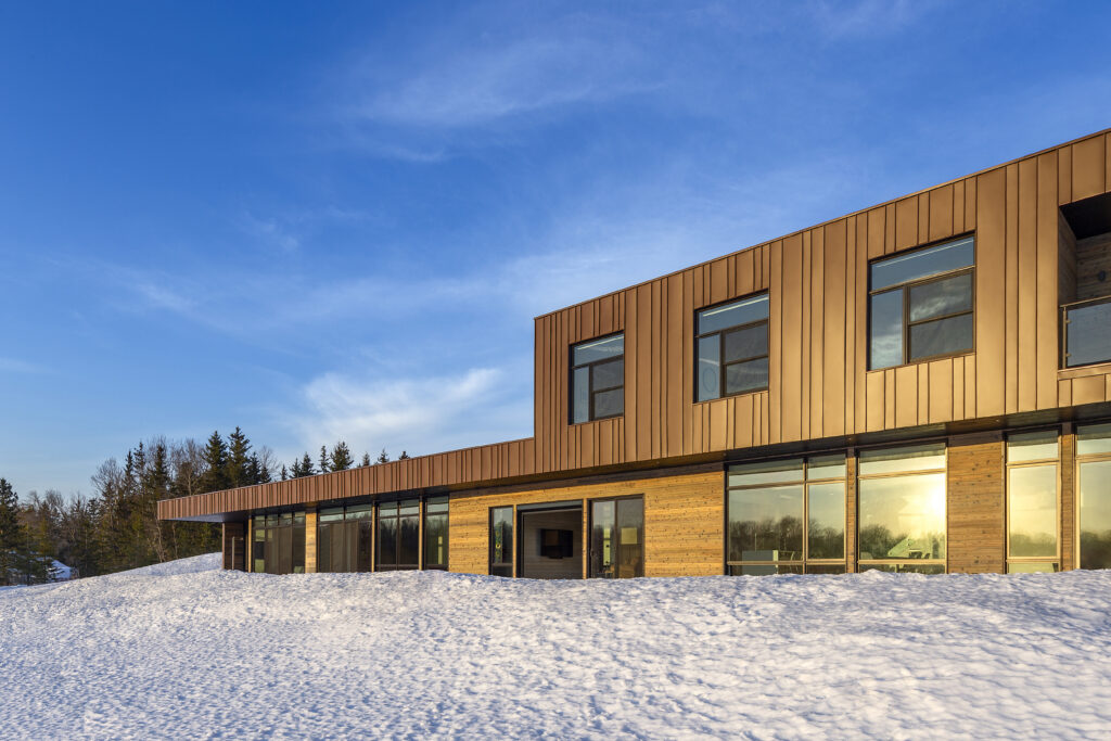 Standing-seam metal clad modern home in the snow