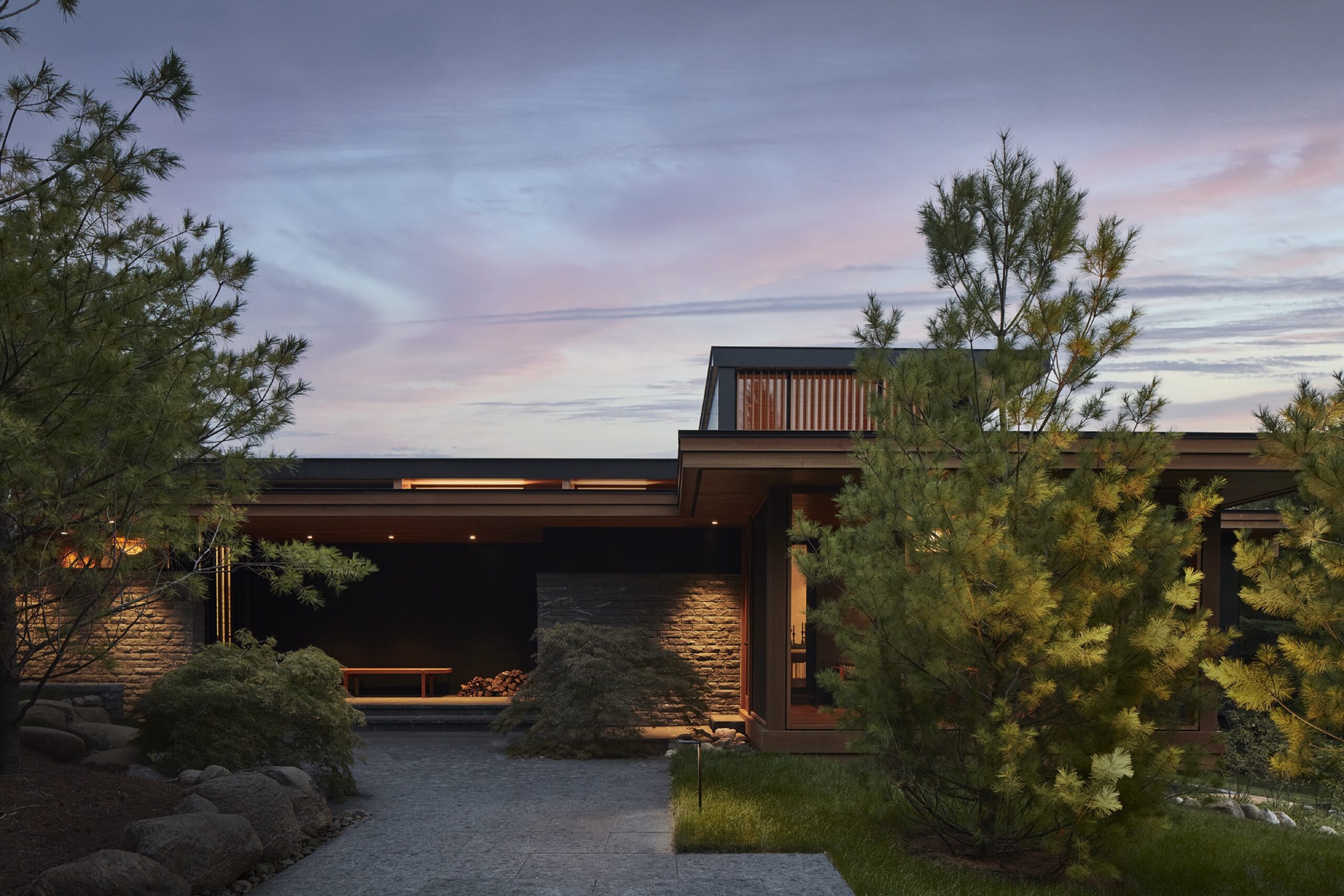 Exterior elevation of a wood, stone, and glass modern home