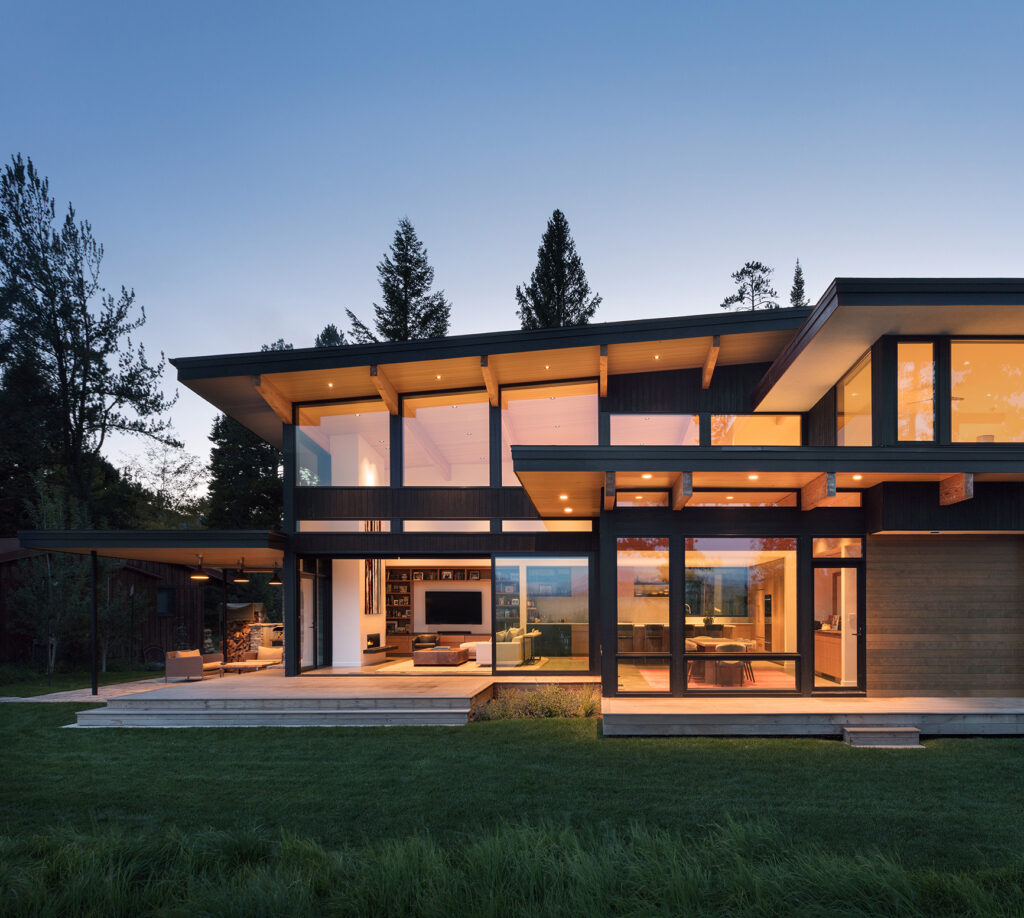Exterior elevational view of a modern mountain home at dusk