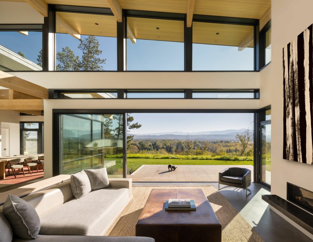 Vue depuis la grande salle d'une maison moderne sur les collines à l'extérieur à la lumière du jour