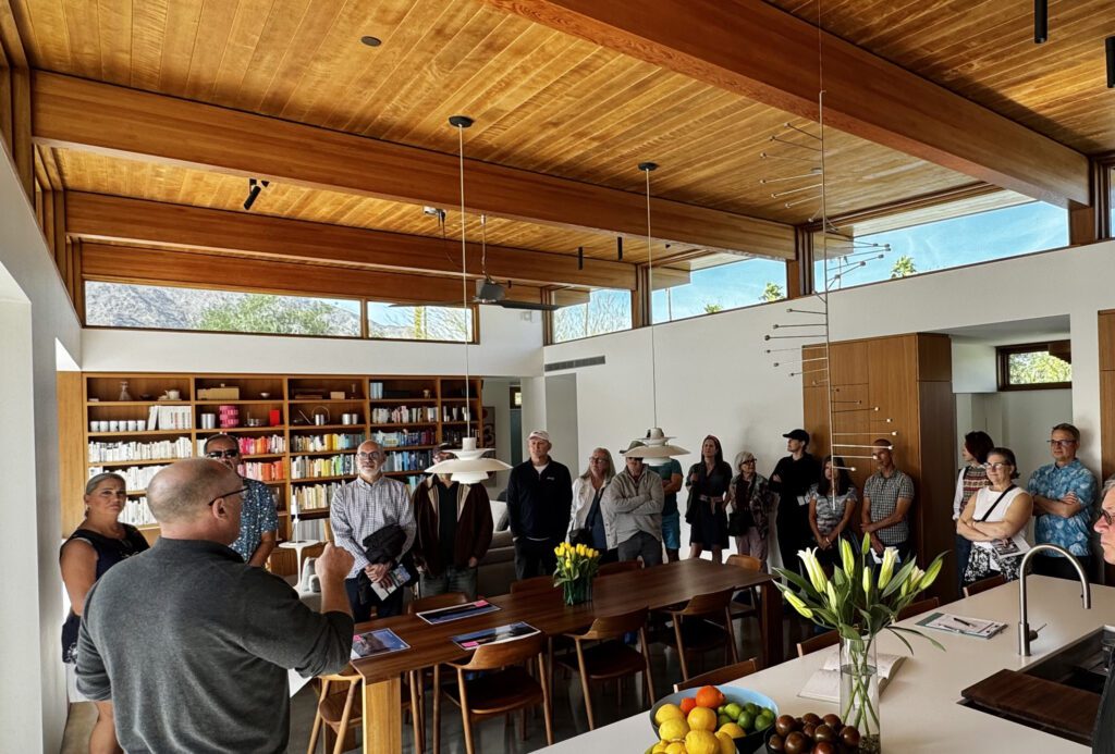 A group of people tour a modern home in Palm Springs