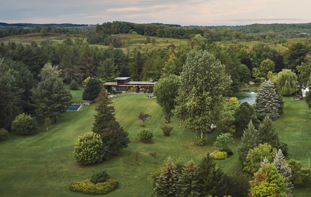 Arial view of a modern home on many acres of Ontario farmland