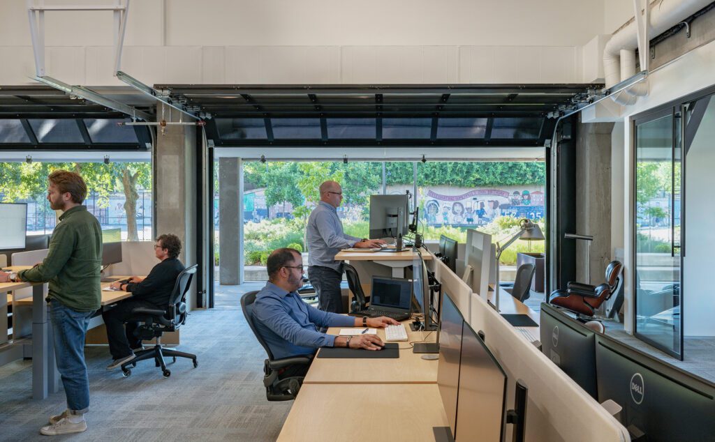 Architects and designers from Turkel Design work at the firm's light-filled Somerville studio.
