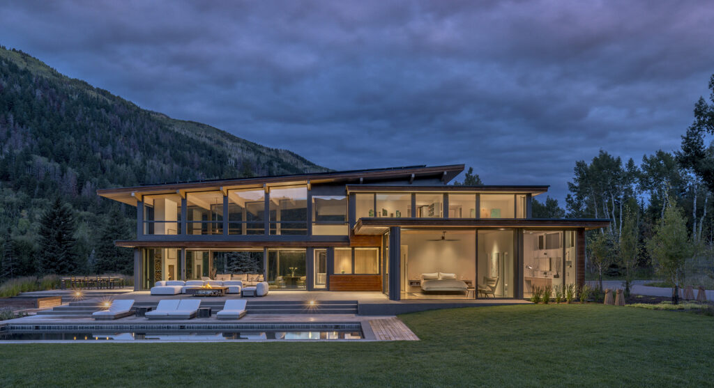 Glass-enclosed modern home in Aspen at dawn